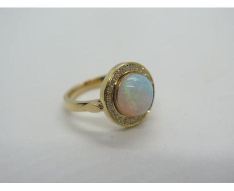 A yellow gold opal and diamond ring, tests to 18ct ring size M/N, approx 6.7 grams, opal approx 9.5mm x 4mm - in very good 