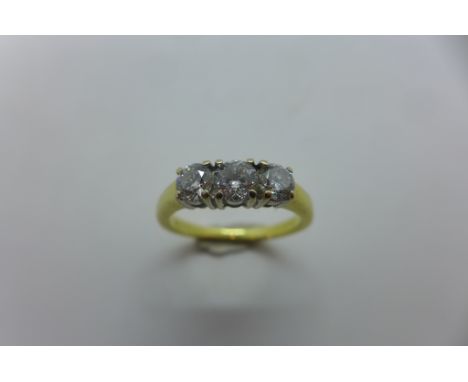 An 18ct yellow gold ring, set with three brilliant cut diamonds - with EGI certificate, approx 1.04ct - ring size P. approx 4