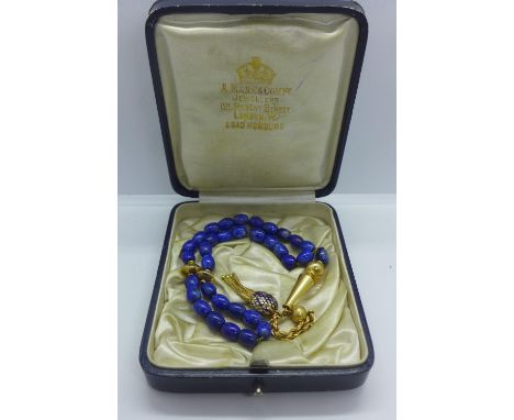 A vintage 18ct tested gold and Lapis Lazuli worry beads, 23cm long, approx 24 grams, minor loss to enamel, otherwise generall