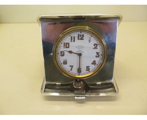 A silver travel watch/clock case with an associated Asprey 8 day watch, not working, glass cracked, silver case weight approx