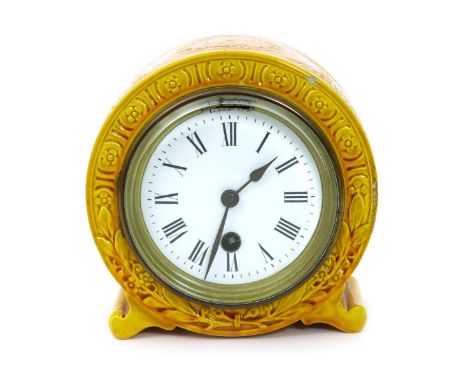 A Burmantofts Faience mantel clock, model no.1259, ovoid on scroll feet, modelled in low relief with stylised foliate panels,