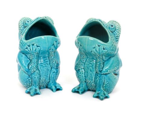 A pair of Burmantofts Faience grotesque frog spoon-warmers, model no.1897, modelled seated with open gaping mouth, glazed tur