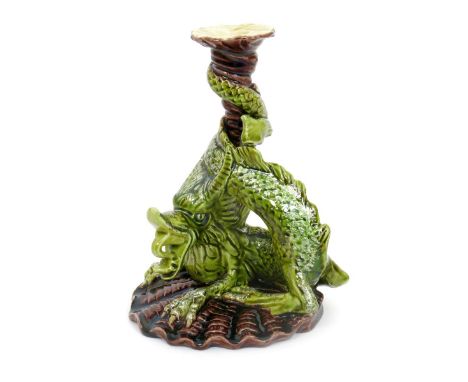 A Burmantofts Faience Dragon candlestick, model no.917, modelled as a ferocious dragon supporting cornucopia sconce, on clam 
