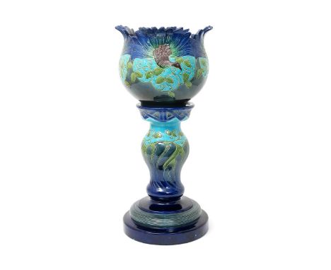 A Burmantofts Faience Partie-Colour jardiniere and stand, model no.2128, the ovoid bowl with fluted rim, incised with peacock