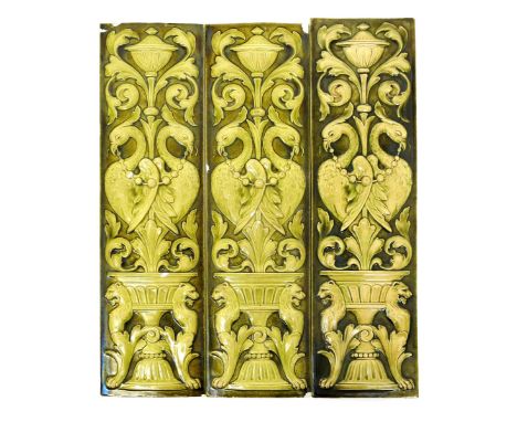Three Burmantofts Faience tile plaques, rectangular, cast in low relief with classical birds amidst scrolling foliage, glazed