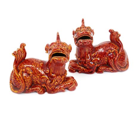 A pair of Burmantofts Faience Kirin figures, model no. 1172, covered in a sang de boeuf, impressed and incised marks, 11cm. w