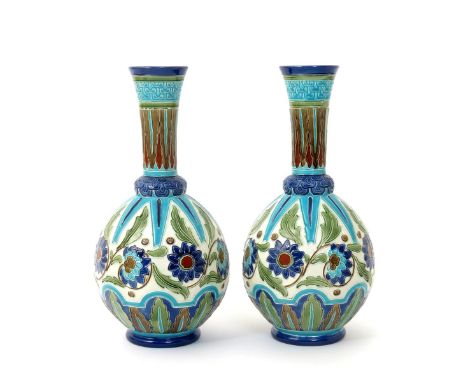 A pair of Burmantofts Faience Partie-Colour bottle vases, model no.2089, ovoid with flaring cylindrical necks, modelled in lo
