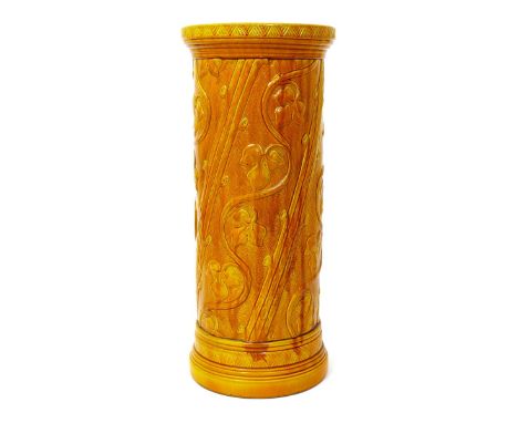 A Burmantofts Faience stick-stand, model no.808, cylindrical with flaring rim, cast in relief with columns of scrolling vine,