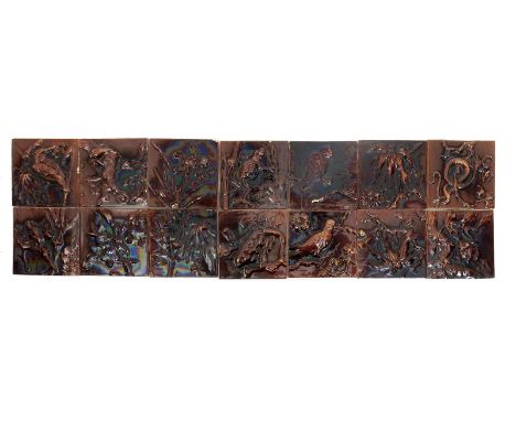 Fourteen Burmantofts Faience tiles, modelled in relief with animals, birds and fauna, comprising, two lizard tiles, a snake, 