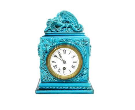 A Burmantofts Faience mantel clock, model no.1431, rectangular section, the top modelled with a grotesque dragon, the sides c
