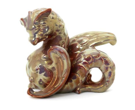A Burmantofts Faience grotesque dragon, model no.2168, modelled rearing up, covered in a golden red lustre glaze, impressed L