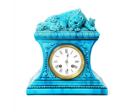 A Burmantoft Faience mantel clock , model no. 1429, waisted, rectangular section, the top modelled in relief with a lioness s