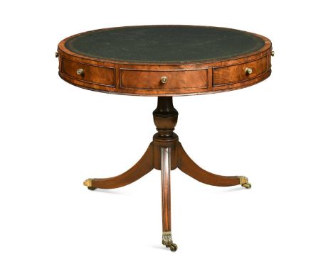 A Regency mahogany drum top library table, the circular top inset with green leather writing surface, over four real and four