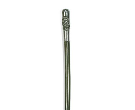 A rhino horn and silver coloured metal handled walking stick, early 20th century, the handle relief decorated with Malay Stat