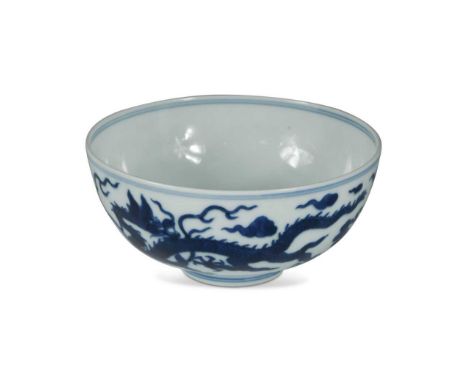 A Chinese blue and white porcelain dragon bowl, bearing seal mark of Daoguang,   painted in Ming style with two dragons benea