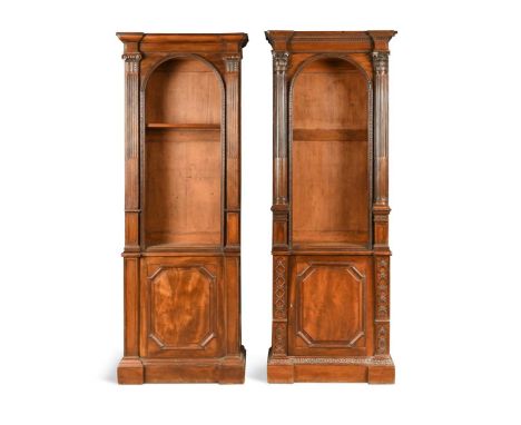 A near pair of mahogany Chippendale style bookcases, late 19th century, the step moulded cornices over an arched recess flank