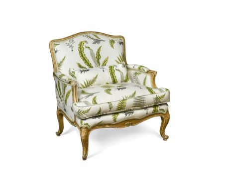 A French Louis XV style bergere armchair, 20th century, of wide proportions, with moulded and gilt painted show frame, uphols