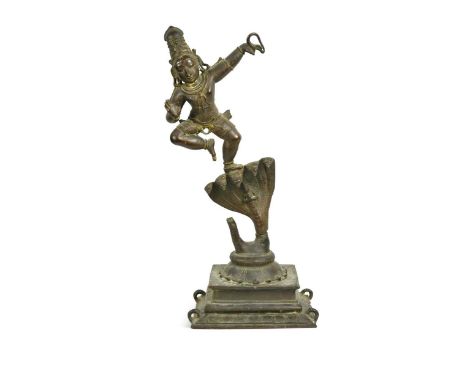 An Indian bronze figure of Krishna dancing on Kaliya, posed on one leg atop the nāga, raised on a lotus dais and stepped plin