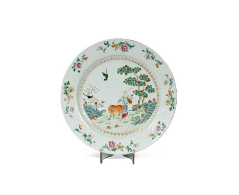 A large Chinese porcelain famille rose plate, 18th century, the centre painted with a lady and an oxen in a landscape, the bo