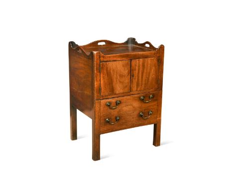 A George III mahogany tray-top night cupboard, the galleried top incorporating carrying handles, with a pair of cupboard door