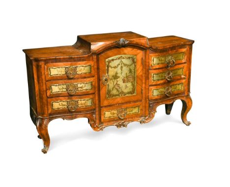 A Continental walnut cabinet in the Rococo style, 19th century, the central cupboard and drawer front with pierced brass shee