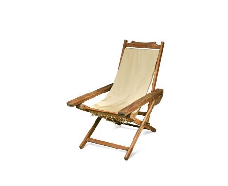 A teak colonial planter's chair, early 20th century, with adjustable back, sling canvas seat and sliding arms97 x 59 x 91cmre