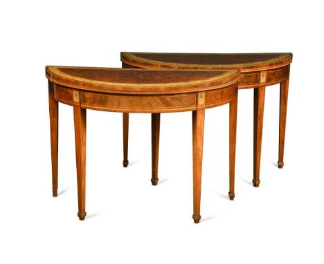 A pair of George III mahogany and inlaid demi lune card tables, the foldover tops with mask and flower basket painted borders