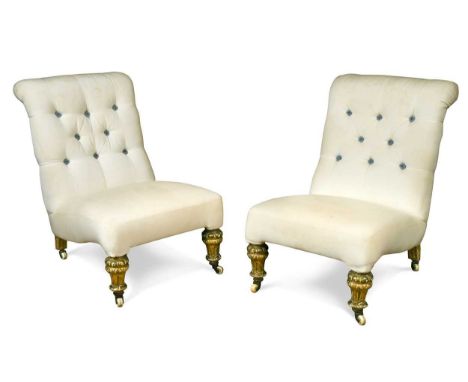 A pair of William IV slipper chairs,  with button back upholstery, on carved giltwood legs and ceramic castors72 x 52 x 80cm 
