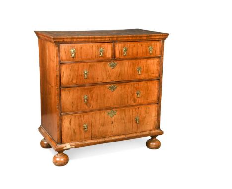 A walnut chest of drawers, early 18th century, the crossbanded top over two short and three long drawers raised on bun feet10