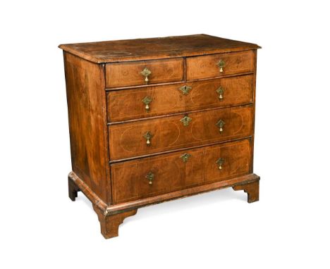 A walnut chest of drawers, late 17th century,  the geometric inlaid top above two short and three long drawers on later brack