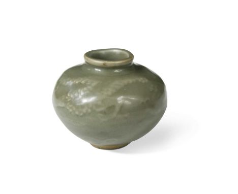 A Chinese celadon glazed dragon jarlet, early Ming Dynasty (1368-1644), the soft olive glaze revealing a sinuous dragon mould