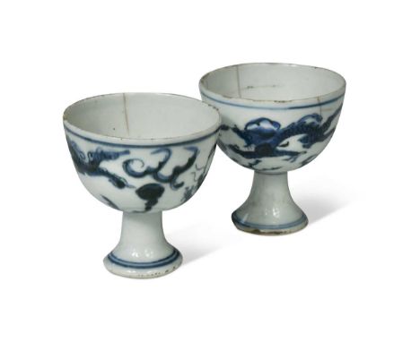 Two Chinese blue and white porcelain dragon stem cups, late Ming Dynasty, circa 1600-1640, each painted with two athletic sky