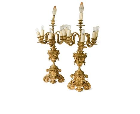 A pair of ormolu candelabra, 19th century,  each with five branches radiating around a central branch, the urn-form stem enci