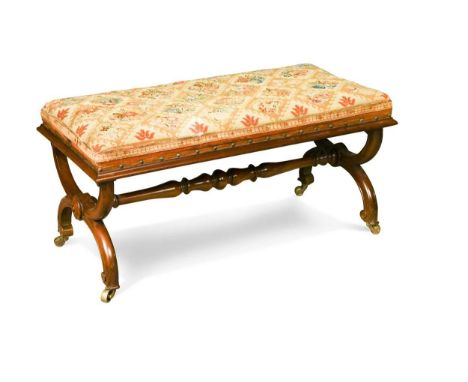 A William IV mahogany cross-frame stool, with a period woolwork seat raised on a scrolled cross-form base united by a turned 