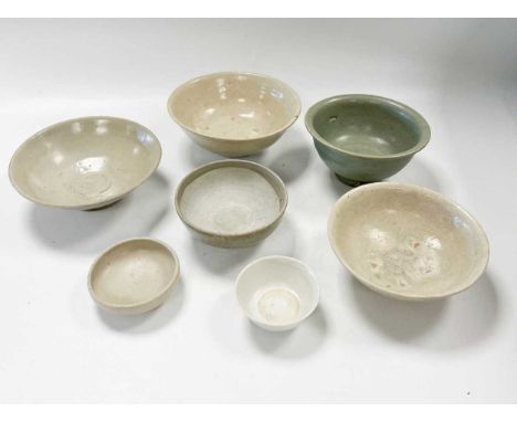 Fourteen assorted Asian provincial porcelain bowls, mainly 14th -18th century, including a Chinese celadon deep bowl, 14cm di