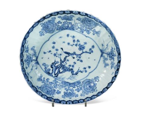 A Chinese blue and white export porcelain oval serving dish, Qianlong circa 1750-60, painted with a songbird in prunus branch