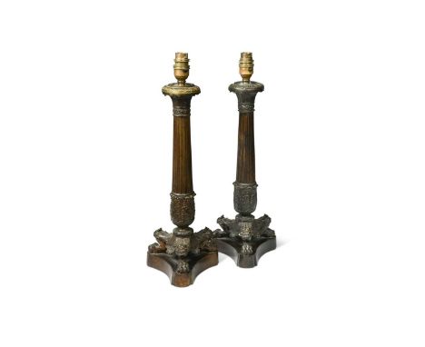 A pair of bronzed triform column table lamps, modern,  each raised on lion paw feet to a plinth base46cm to top of bulb fitti