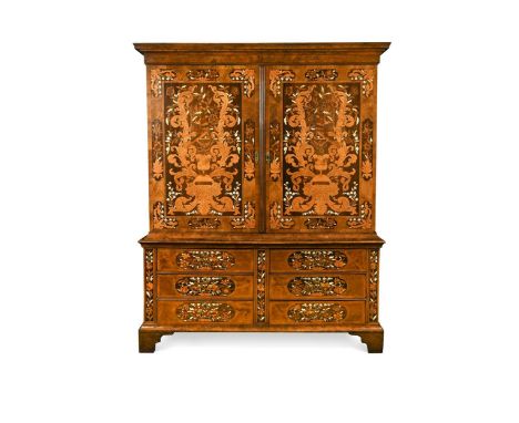 A Dutch walnut and marquetry linen press, 18th century, decorated with marquetry depicting vases of flowers including tulips 