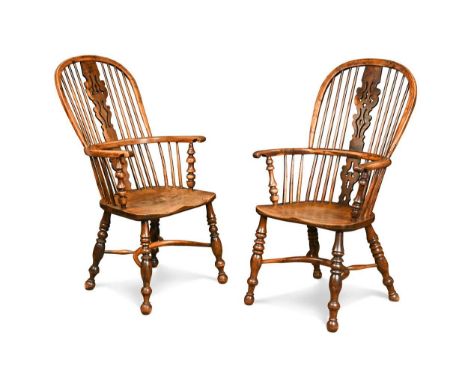 A pair of yew wood and elm Windsor armchairs, 19th century, the rounded arch backs with central pierced splat flanked by turn