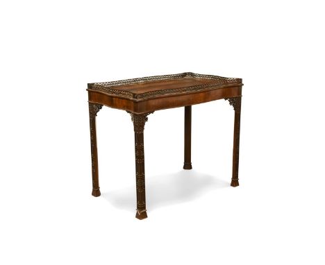 A Chippendale style mahogany silver table, late 19th century, the serpentine shaped top with fretwork gallery on moulded legs