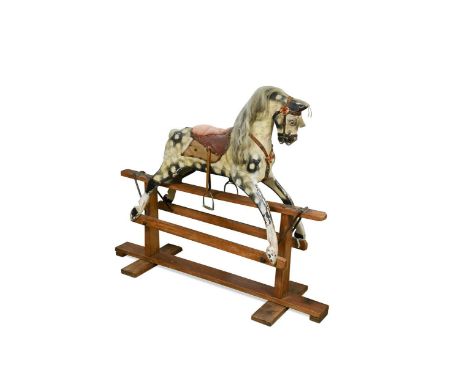 A carved and painted wooden rocking horse, early 20th century, the dappled horse with metal eyes, horse hair mane and tail, l