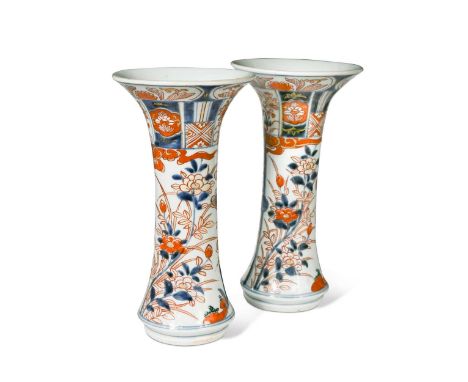 A pair of Japanese Imari vases, Edo Period, 18th century, of trumpet shape, painted with room interiors and rampant peonies24