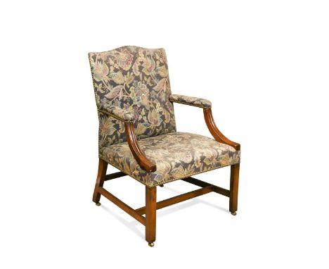 A George III mahogany Gainsborough library armchair, the arched back, seat and armrests upholstered in a floral fabric, the m