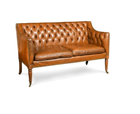 A leather two seater sofa in the manner of Gillows, 19th century, the rectangular back, sides and seat cushions upholstered i