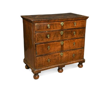 A walnut chest of drawers, early 18th century, the inlaid top with moulded edge, comprising four long drawers raised on three