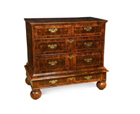 An oyster veneered chest on stand, late 17th century, the inlaid top above two short over three long drawers on a stand with 