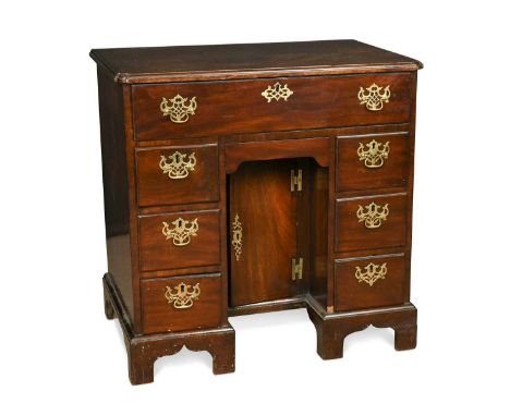 A George III mahogany kneehole desk, with fitted slide out top drawer above an arrangement of six drawers and kneehole cupboa