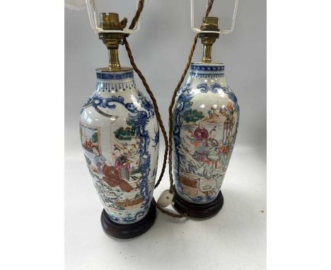 A pair of Chinese famille rose export porcelain vases, circa 1790,  of slender ovoid form, each painted with two scroll borde