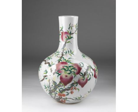 Chinese Art A monumental tianqiuping vase in white porcelain decorated with peaches and flowers and bearing a Qianlong iron r