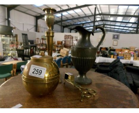 A brass Lipton's tea caddy, a wick cutter, a candlestick and a pewter ewer